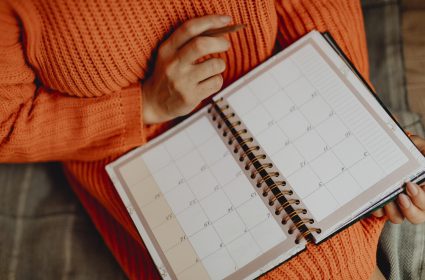 Woman writing on her daily planner